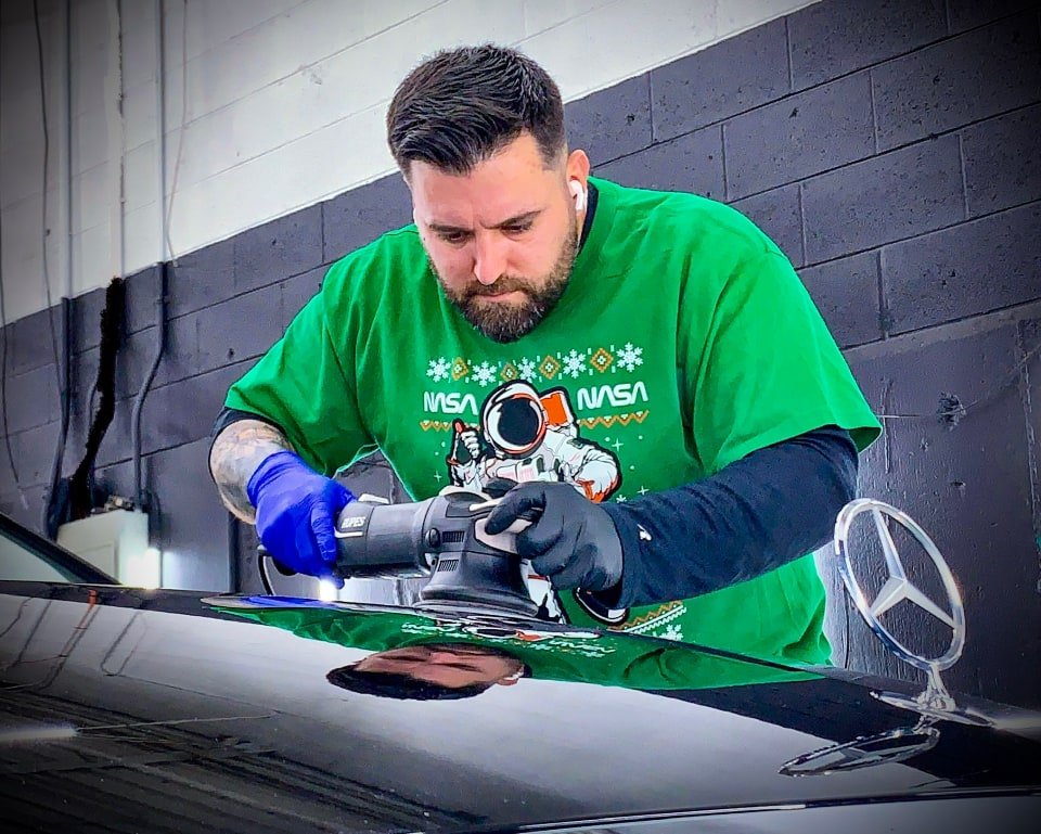 Justin Pool buffing a car hood